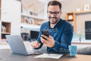 Young businessman working at home using lap top